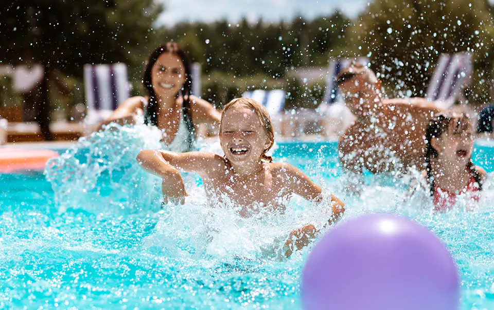 Family and kids playing in the pool at Villa Grove Property